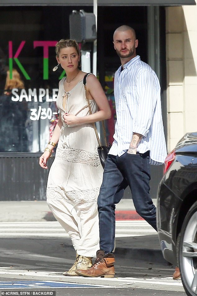 Sunday outing: The Aquaman star, who was accompanied by a male companion, paired her outfit with snakeskin boots and carried a black purse on a gold shoulder chain