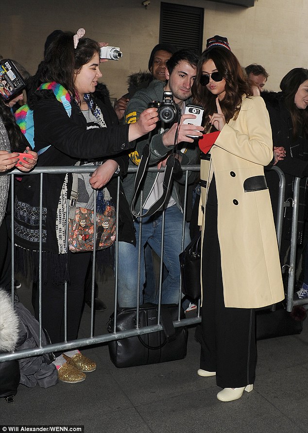 Good to see you: Despite her early start, Selena was in high spirits as she spent time with fans outside the London studio