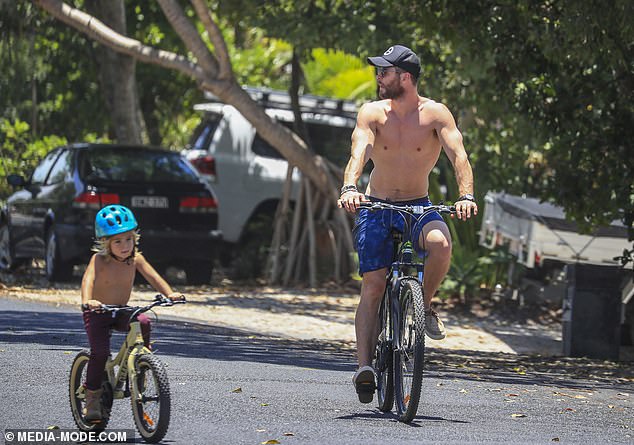 Fun in the sun! Pedalling along beside their parents were Chris and Elsa's children, daughter India Rose, six, and twin sons Tristan and Sasha, four