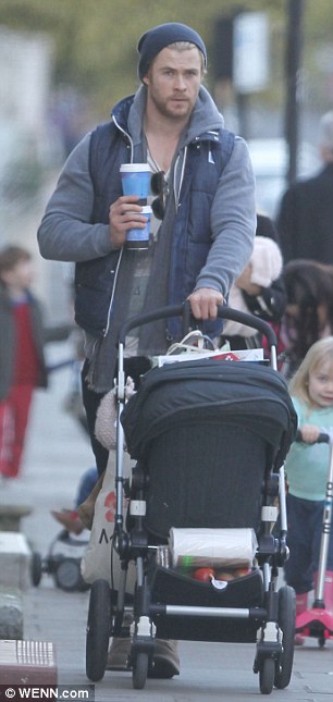 Multitasker: The actor showed off his impressive balancing and arm strength as he juggled two cups of coffee while pushing the pram