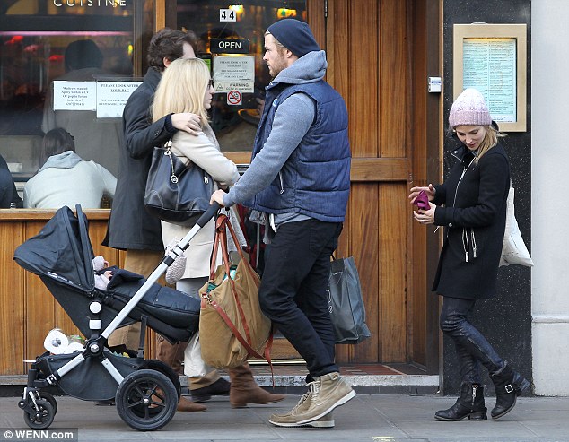 Yummy mummy: Elsa showed off her inner rock chick in a black coat, leather look trousers and biker boots