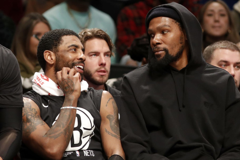 NEW YORK, NEW YORK - JANUARY 30: (NEW YORK DAILIES OUT) Kyrie Irving #11 (L) and Kevin Durant #7 of the Brooklyn Nets look on against the Los Angeles Lakers at Barclays Center on January 30, 2023 in New York City. The Nets defeated the Lakers 121-104. NOTE TO USER: User expressly acknowledges and agrees that, by downloading and or using this photograph, User is consenting to the terms and conditions of the Getty Images License Agreement. (Photo by Jim McIsaac/Getty Images)